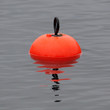 Isolated floating orange buoy closeup, Norway sea