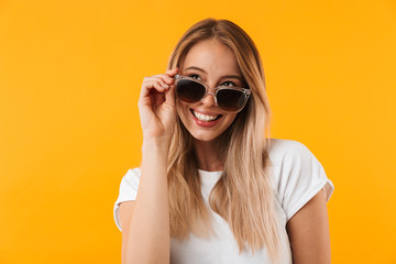 Wall Mural - Portrait of a joyful young blonde girl in sunglasses