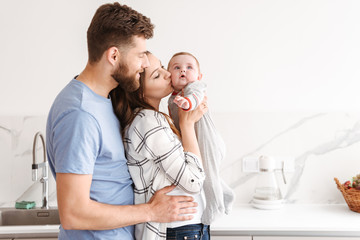 Happy parents having fun with their little baby.