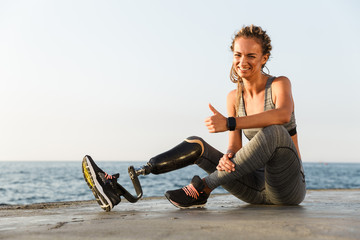 Wall Mural - Smiling disabled athlete woman with prosthetic leg