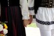 bride wearing a traditional hungarian wedding dress and groom in a traditional romanian costume - intereethnic marriage
