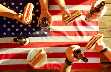 4th Of July Celebration Party, Young Men Hands Holding Beer Bottle, Holiday Label Design, Happy Independence Day, Hot Dog, Mustard, Catchup. American Flag, River Recreation Area. Close Up, Background