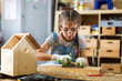 © pikselstock - Girl building birdhouse in garage