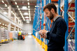 © Stock Rocket - Manager in warehouse holding digital tablet
