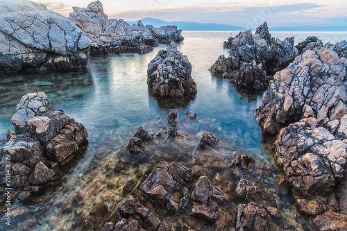 Photographie Long exposure of sea rocks during sunset
