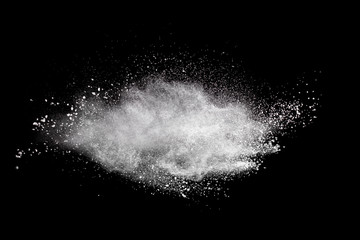 Bizarre forms of  white powder explosion cloud against dark background. Launched white particle splash on black background