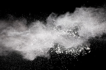 Wall Mural - Bizarre forms of  white powder explosion cloud against dark background. Launched white particle splash on black background