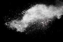 Bizarre Forms Of  White Powder Explosion Cloud Against Dark Background. Launched White Particle Splash On Black Background.