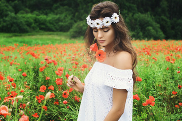 Wall Mural - Beautiful woman in field with a lot of poppy flowers