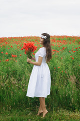 Wall Mural - Beautiful woman in field with a lot of poppy flowers