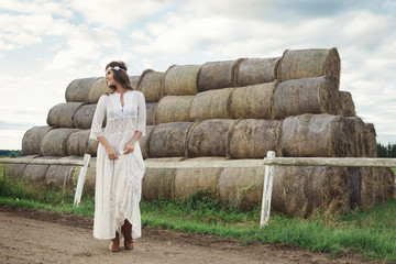 Wall Mural - Woman wearing stylish white dress in the country side