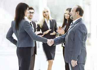 handshake of business partners after signing the contract