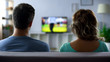 © motortion - Bored couple watching football match on tv, conflict, passive pastime together
