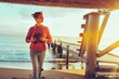 © tinyakov - Hiker Girl With Binoculars In Hand Standing By The Sea Near Pier And Enjoying View Of Nature, Front View