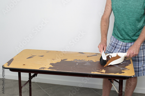 Male Cleans Off Table He Is Preparing To Resurface Sweeping Male Cleans Off Table He Is Preparing To Resurface Sweeping A With