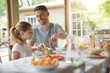 © goodluz - Portrait of man with little girl eating lunch together