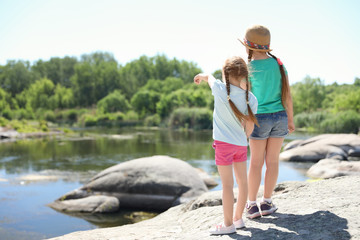 Wall Mural - little girls at riverside. summer camp