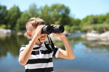 Wall Mural - little boy with binoculars outdoors. summer camp