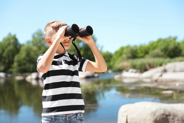 Wall Mural - little boy with binoculars outdoors. summer camp