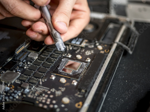 Close Up Hands With Thermal Paste Apply It To Laptop Cooler