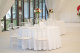Fototapeta Lawenda - luxury airy summer restaurant in white with transparent chairs and ready to party