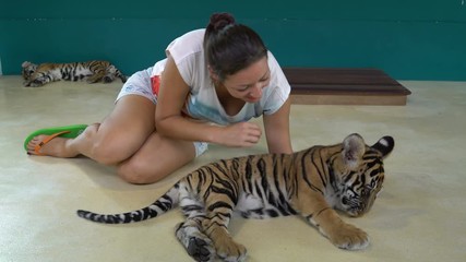 Woman plays with Tiger Cub