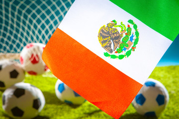 Flag of Mexico with a soccer ball. Football competitions. Flag of Mexico at the football stadium. Goalkeeper's goal. Swords lie in the football goal.