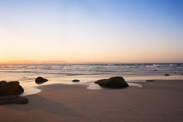 Wall Mural - The pinky sunset on the deserted beach in Byron Bay, Australia