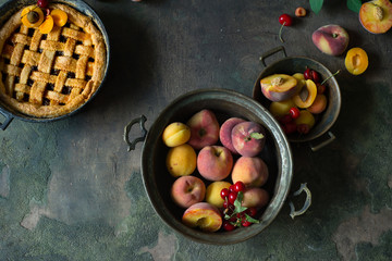 Wall Mural - Fruit pie on colorful wooden rustic background with fresh peaches