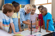 © Rido - Teacher showing abacus to children