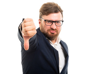 Wall Mural - Portrait of business man showing thumb down gesture.