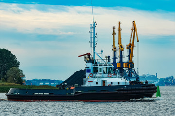 Canvas Print - Black tug ship underway