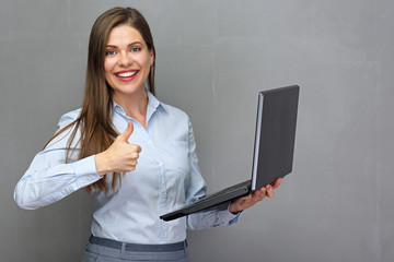 businesswoman holding open laptop doing thumb up