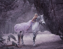 A Fairy In A Purple, Transparent Dress With A Long Flying Train Lies On A Unicorn. Sleeping Beauty. Blonde Girl Walking With Pegasus In The Forest. The Elven Song. Artistic Processing.