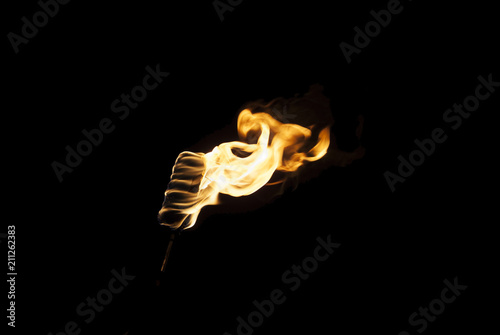Cuadros en Lienzo flame of a torch in the dark on a black background, only the fire is visible