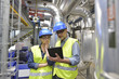 © goodluz - Industrial engineers working in recycling plant with tablet