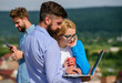 © be free - Colleagues business partners with laptop and smartphone taking advantages of mobile internet working outdoor. Colleagues with laptop work outdoor sunny day, nature background. Mobile internet concept
