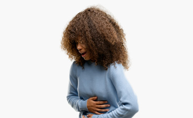 Sticker - African american woman wearing a sweater with hand on stomach because nausea, painful disease feeling unwell. Ache concept.