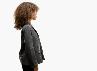 Poster - African american business woman wearing glasses looking to side, relax profile pose with natural face with confident smile.