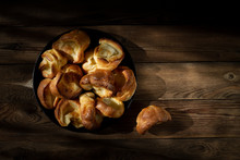 Yorkshire Puddings In A Cast-iron Frying Pan On A Wooden Table. Rustic Style