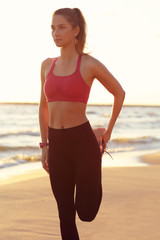 Wall Mural - Woman running alone at beautiful dusk on the beach