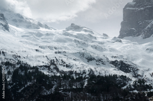 Fényképezés  Gigantic blizzard snow storm clouds casting over the mountain peaks