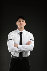 Wall Mural - Male security guard in uniform on dark background