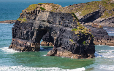 Wall Mural - Ballybunnion beach, west Ireland, aerial view over the sand beach and stone arch, Ring of Kerry