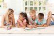 © Africa Studio - Cute children drawing with parents at home