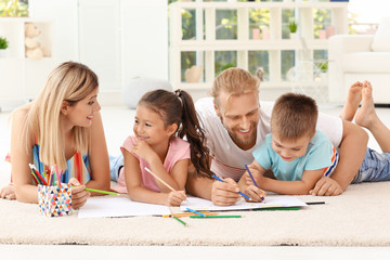 Wall Mural - Cute children drawing with parents at home