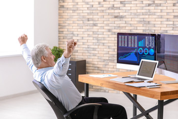 Wall Mural - Male broker working in office. Finance trading concept