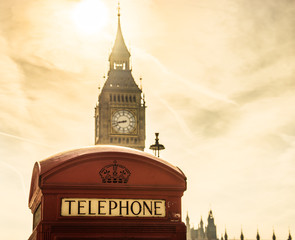 Sticker - Traditional red British telephone box and Big Ben on blurry background 