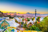 Fototapeta  - View of mosaic tile and Barcelona cityscape in park Guell at sunset | Spain