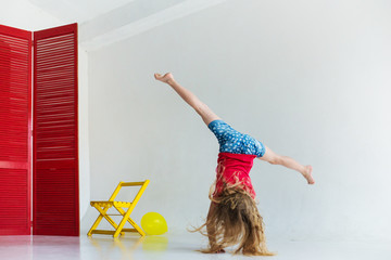 Little girl young athlete who practices gymnastics in gym